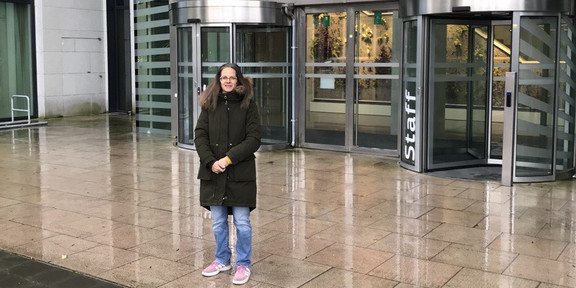 Prof. Madeo in front of building