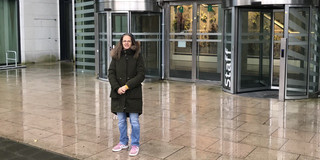 Prof. Madeo in front of building