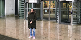 Prof. Madeo in front of building